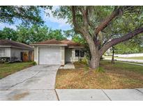 Charming single-Gathering home with attached garage and mature landscaping at 402 Abigail Rd, Plant City, FL 33563