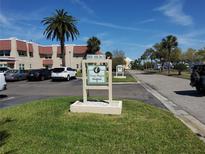 Inviting community sign and landscaping at the entrance to the lovely homes at 10034 64Th N Ave # 11, St Petersburg, FL 33708