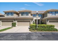 Charming multi-Gathering home featuring well-maintained landscaping, garages, and a warm, inviting facade at 13208 San Blas Loop, Largo, FL 33774