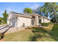 Charming single-story home featuring a well-manicured lawn and attached two car garage at 13526 Norman Cir, Hudson, FL 34669