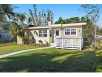 Charming single-story home with a well-manicured lawn, quaint front porch, and lovely curb appeal at 3220 10Th N St, St Petersburg, FL 33704