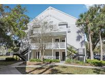Charming condo complex with well-maintained grounds and inviting staircases, enhanced by lush trees at 3310 Haviland Ct # 202, Palm Harbor, FL 34684