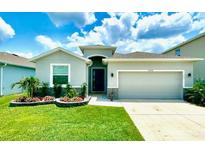 Charming single-story home with well-maintained lawn and manicured landscaping, enhancing its curb appeal at 33298 Major Oak Dr, Wesley Chapel, FL 33545