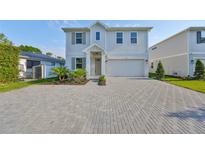 Charming two-story home with landscaped yard and brick paved driveway at 3915 W Euclid Ave, Tampa, FL 33629
