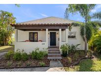 Inviting front porch with stylish seating and a decorative front door at 409 Erie Ave, Tampa, FL 33606