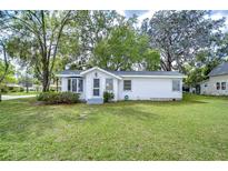 Charming single-story home with a well-maintained lawn and mature trees at 5313 11Th St, Zephyrhills, FL 33542