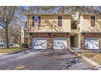 Charming townhome featuring stone accents, attached garages, and a welcoming entryway, perfect for comfortable living at 10115 Courtney Palms Blvd # 202, Tampa, FL 33619