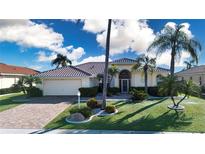 Charming single-story home featuring lush landscaping, a brick driveway and a neutral color palette at 1308 Crystal Greens Dr, Sun City Center, FL 33573