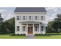 Charming two-story home with symmetrical design, gray siding, shutters, and a welcoming front porch at 1428 50Th N Ave, St Petersburg, FL 33703