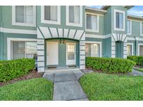 Charming townhome featuring a lush front lawn and well-maintained landscaping at 2263 Fluorshire Dr, Brandon, FL 33511