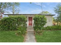 Charming home with a well-manicured lawn and inviting red front door at 2465 9Th N Ave, St Petersburg, FL 33713