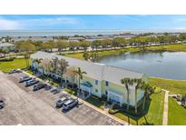 Bright yellow townhome with manicured lawn and water views in beach community at 4766 Snook Se Dr, St Petersburg, FL 33705