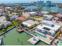 Stunning waterfront property with pool, boat dock, and views of the bay in a coastal community at 540 59Th Ave, St Pete Beach, FL 33706