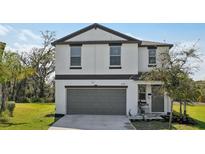 Charming two-story home with a two-car garage and well-maintained landscaping at 11944 Miracle Mile Dr, Riverview, FL 33578