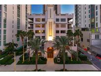 Stunning building exterior with palm trees and manicured landscaping in a vibrant urban setting at twilight at 146 4Th Ne Ave # 600, St Petersburg, FL 33701