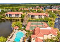 Beautiful aerial view of the community featuring a pool, tennis courts and lake views at 2400 Feather Sound Dr # 1118, Clearwater, FL 33762