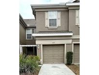 Charming townhouse exterior with well-maintained landscaping at 4133 Bismarck Palm Dr, Tampa, FL 33610