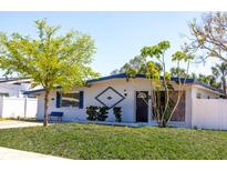 Charming single-story home featuring a well-maintained lawn and distinctive architectural details, enhancing curb appeal at 4402 Ohio Ave, Tampa, FL 33616