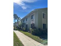 A charming multi-Gathering home with well-maintained landscaping and palm trees on a sunny day at 20861 Haulover Cv # 5, Lutz, FL 33558