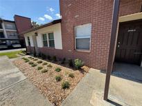 Charming condo exterior boasts tidy landscaping and well-maintained brick facade at 2440 Enterprise Rd # 2, Clearwater, FL 33763