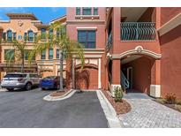 Beautiful condominium building with a private garage and palm trees in a well-maintained community at 2730 Via Tivoli # 321B, Clearwater, FL 33764