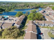 Stunning aerial view of lakeside apartments with lush greenery and a sparkling swimming pool at 4004 Cortez Dr # D, Tampa, FL 33614