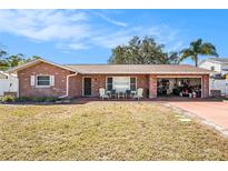 Charming brick home featuring a covered entry and an attached two-car garage at 12280 90Th Ave, Seminole, FL 33772