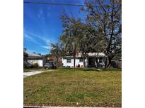 Charming single-story home with a well-maintained lawn and mature trees at 127 81St Ne Ave, St Petersburg, FL 33702
