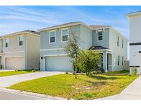 Charming two-story home features a well-manicured lawn and a two-car garage at 16051 Weathered Windmill Ter, Odessa, FL 33556