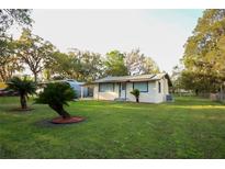 Charming single-story home with a well-maintained lawn and updated exterior paint at 19455 Fort Dade Ave, Brooksville, FL 34601