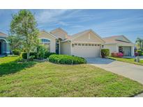 Charming single-story home featuring a well-manicured lawn and a neutral-toned exterior at 2514 Sandy Hill Ct, Holiday, FL 34691