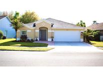 Charming single-story home featuring a well-manicured lawn and attached two car garage at 5702 War Admiral Dr, Wesley Chapel, FL 33544