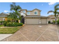 Charming two-story home boasts a three-car garage, mature landscaping, and beautiful neutral color palette at 6239 French Creek Ct, Ellenton, FL 34222