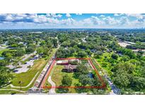 An aerial view of a rural property with a house, garden, and surrounding greenery, showing its spacious layout at 6501 62Nd N St, Pinellas Park, FL 33781