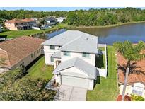 Lovely two story home with a two car garage and a large yard overlooking a scenic lake at 25631 Bruford Blvd, Land O Lakes, FL 34639