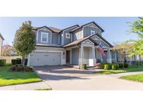 Beautiful two-story home with a well-manicured lawn, attached two car garage, and an inviting brick paved driveway at 2671 Murray Pass, Odessa, FL 33556