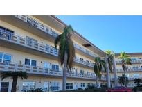 Exterior shot of a condo complex with multiple units, balconies, and palm trees at 5725 80Th N St # 314, St Petersburg, FL 33709
