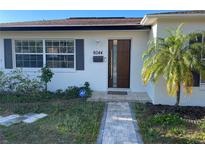 Charming home exterior with a modern front door, a walkway and lovely landscaping at 6044 6Th N Ave, St Petersburg, FL 33710