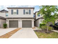Attractive two-story townhouse featuring a private garage and neutral-toned exterior at 607 Royal Empress Dr, Ruskin, FL 33570