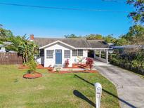 Charming single-story home with a well-manicured lawn and covered parking area at 6316 S Richard Ave, Tampa, FL 33616