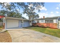 Charming single-story home with brick accents, light blue siding, and a well-maintained front yard at 910 Edgedale Cir, Brandon, FL 33510