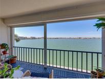 Enjoy the calming water views from this comfortable outdoor balcony with seating at 7910 Sun Island S Dr # 301, South Pasadena, FL 33707