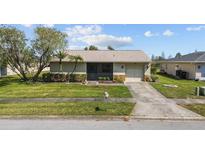 Charming one-story home with well-manicured lawn, mature landscaping, and an inviting front entrance at 10701 41St N Ct, Clearwater, FL 33762