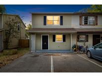 Two story townhome featuring neutral paint scheme, black shutters and ample parking spaces at 156 Douglas W Rd # C, Oldsmar, FL 34677