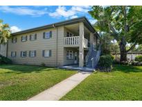 A charming two-story apartment building showcases a manicured lawn and inviting walkway at 426 32Nd N Ave # 102E, St Petersburg, FL 33704