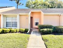 Inviting single-story home featuring a well-maintained lawn and charming curb appeal with lush green shrubbery at 4816 Grist Mill Cir # 4816, New Port Richey, FL 34655