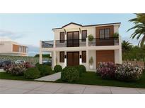 Modern two-story home showcasing a balcony, manicured lawn and tasteful landscaping at 5000 Chancellor Ne St, St Petersburg, FL 33703