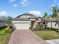 Charming single-Gathering home boasting well-manicured landscaping and a brick driveway at 7515 37Th E Ave, Palmetto, FL 34221