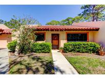 Charming home with a well-manicured front yard and a welcoming front entrance with a tile roof at 9769 86Th Ave # 9769, Seminole, FL 33777