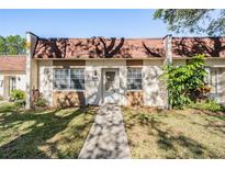 Inviting home exterior featuring a well-manicured lawn, tidy landscaping, and a cozy front entryway at 11511 113Th St # 22E, Largo, FL 33778